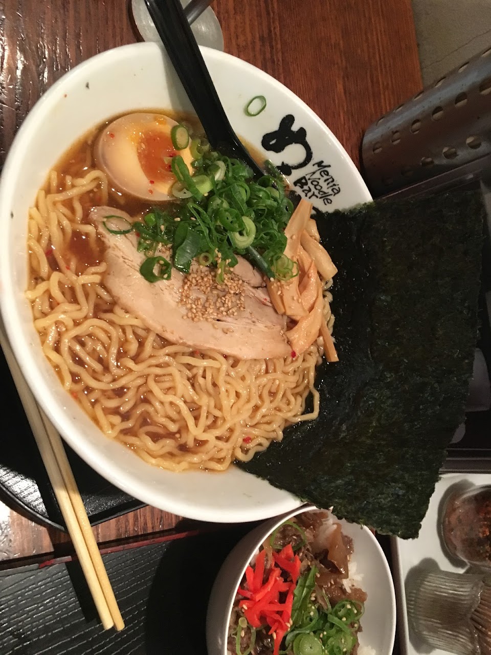 Menya ramen bowl with noodles, pork, egg, spring onion, and nori